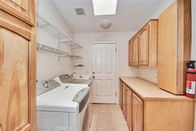 9920 Sage St, Oak Hills, CA 92344 - laundry area featuring cabinet space, separate washer and dryer, and light tile patterned floors