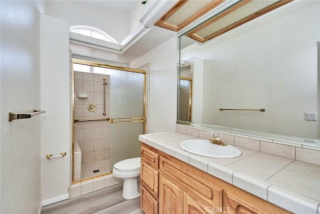9920 Sage St, Oak Hills, CA 92344 - bathroom featuring toilet, a stall shower, vanity, and wood finished floors