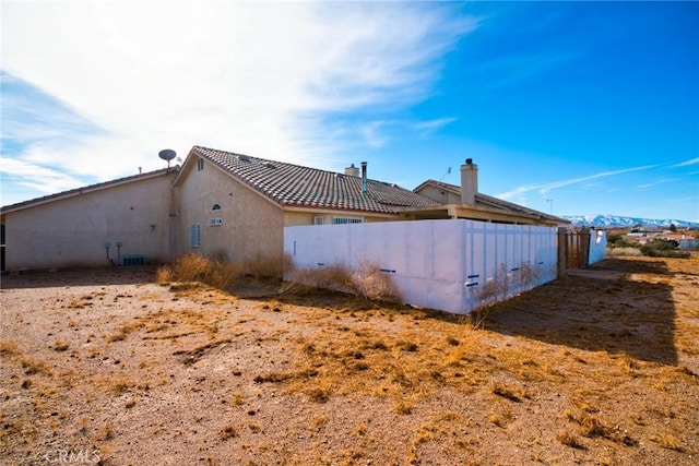 9920 Sage St, Oak Hills, CA 92344 - rear view of house with stucco siding