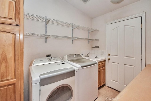 9920 Sage St, Oak Hills, CA 92344 - laundry room featuring cabinet space, washer and dryer, and light tile patterned floors