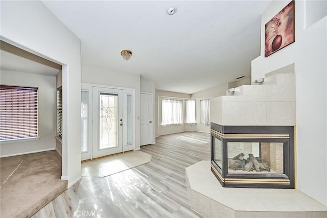 9920 Sage St, Oak Hills, CA 92344 - entryway with wood finished floors, a fireplace, vaulted ceiling, and baseboards