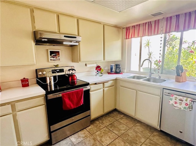 4 Camphor S, Irvine, CA 92612 - kitchen with stainless steel appliances, under cabinet range hood, a sink, cream cabinets, and light countertops