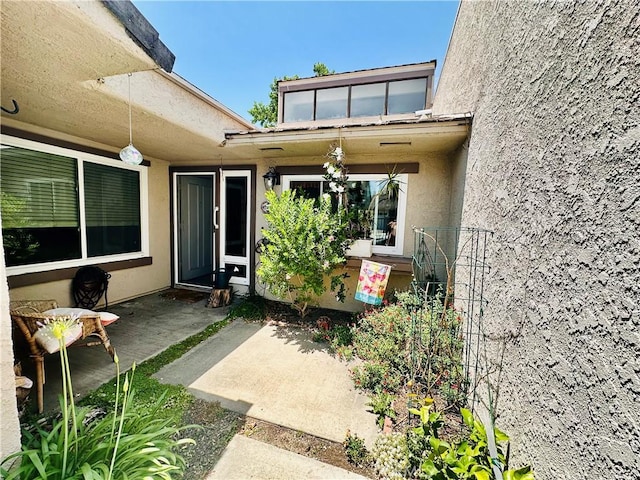 4 Camphor S, Irvine, CA 92612 - view of exterior entry featuring stucco siding and a patio