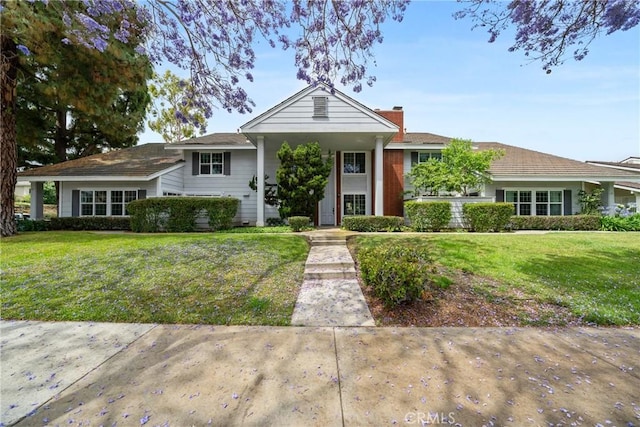 43 W Yale Loop Unit 29, Irvine, CA 92604 - view of front of home with a front lawn and a chimney
