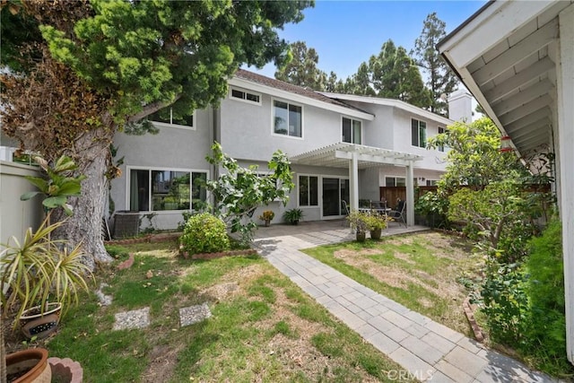43 W Yale Loop Unit 29, Irvine, CA 92604 - rear view of property with stucco siding, a pergola, and a patio area