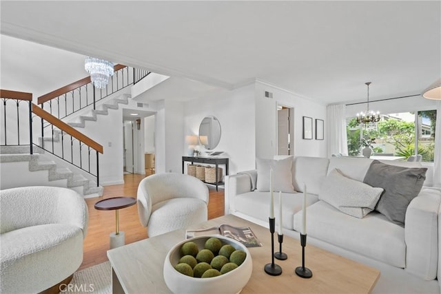 43 W Yale Loop Unit 29, Irvine, CA 92604 - living area featuring a chandelier, stairs, wood finished floors, and crown molding