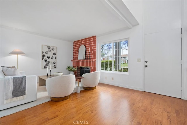 43 W Yale Loop Unit 29, Irvine, CA 92604 - living room featuring a fireplace, wood finished floors, and beam ceiling