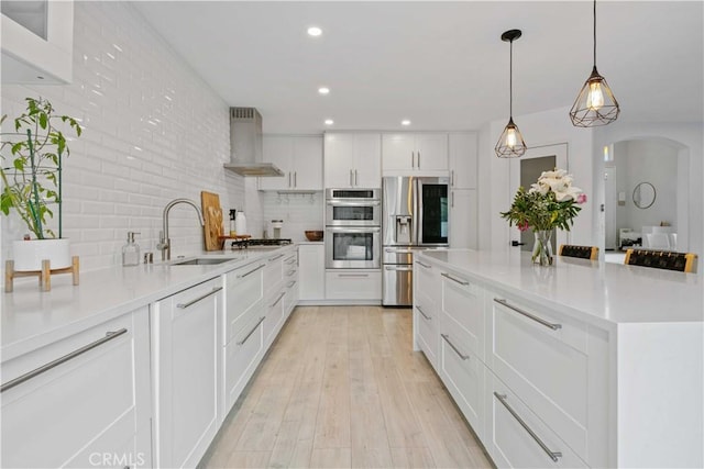 17913 Maplehurst Pl, Canyon Country, CA 91387 - kitchen featuring a sink, wall chimney exhaust hood, stainless steel appliances, white cabinetry, and recessed lighting