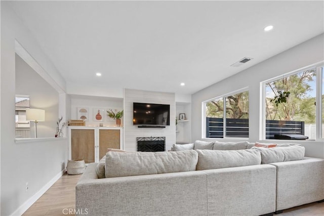 17913 Maplehurst Pl, Canyon Country, CA 91387 - living area with plenty of natural light, light wood-type flooring, a fireplace, recessed lighting, and baseboards