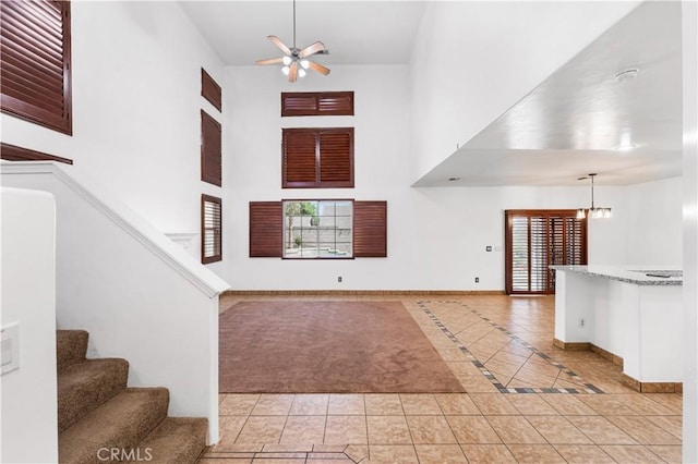 2904 Granite Ridge Pl, Bakersfield, CA 93313 - entryway with a high ceiling, ceiling fan, baseboards, a chandelier, and stairs