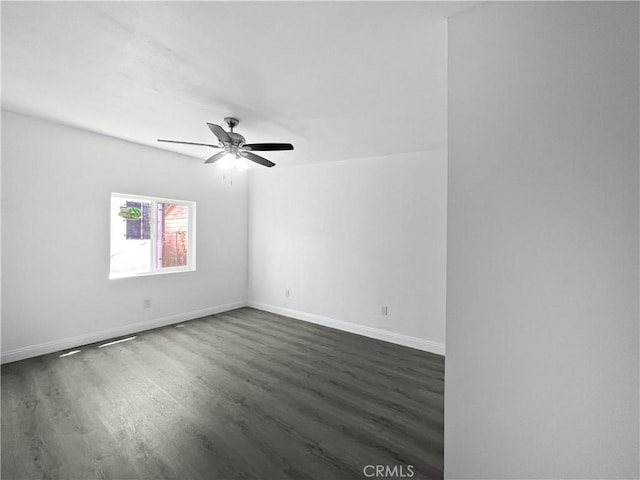 10405 S Hoover St, Los Angeles, CA 90044 - unfurnished room with dark wood-style floors, ceiling fan, and baseboards