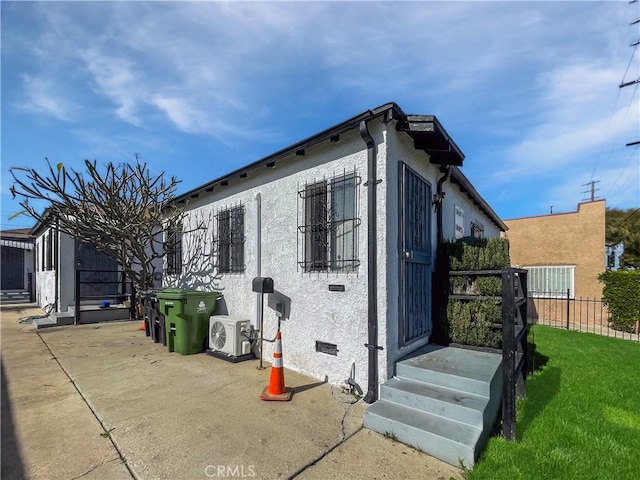 10405 S Hoover St, Los Angeles, CA 90044 - view of side of property featuring stucco siding and ac unit