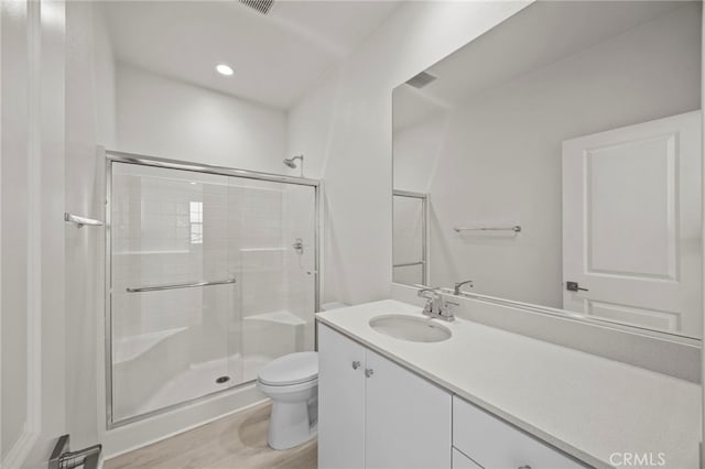 16145 Sandpiper Ave, Chino, CA 91708 - bathroom featuring toilet, a stall shower, vanity, wood finished floors, and recessed lighting