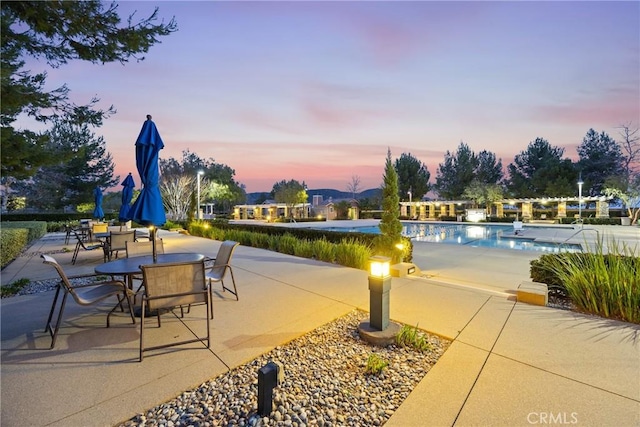 3883 Taconite Rd, San Bernardino, CA 92407 - patio terrace at dusk with a patio area and a community pool