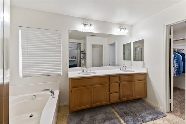 3883 Taconite Rd, San Bernardino, CA 92407 - full bath featuring double vanity, a bath, a walk in closet, and tile patterned floors