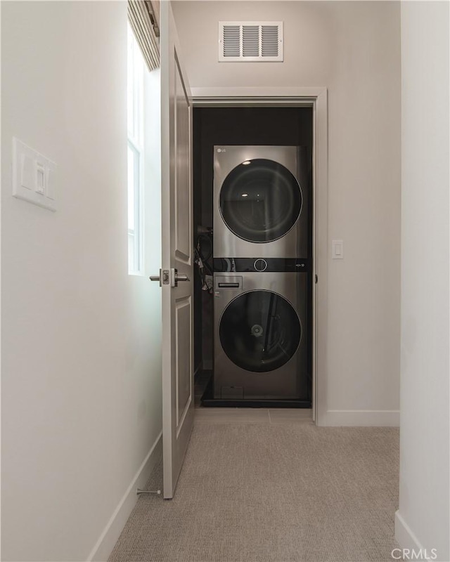 21 Welltree Way, Rancho Mission Viejo, CA 92694 - washroom featuring stacked washer / dryer, carpet flooring, and baseboards