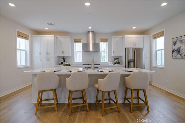 21 Welltree Way, Rancho Mission Viejo, CA 92694 - kitchen featuring wall chimney range hood, stainless steel fridge with ice dispenser, plenty of natural light, and recessed lighting