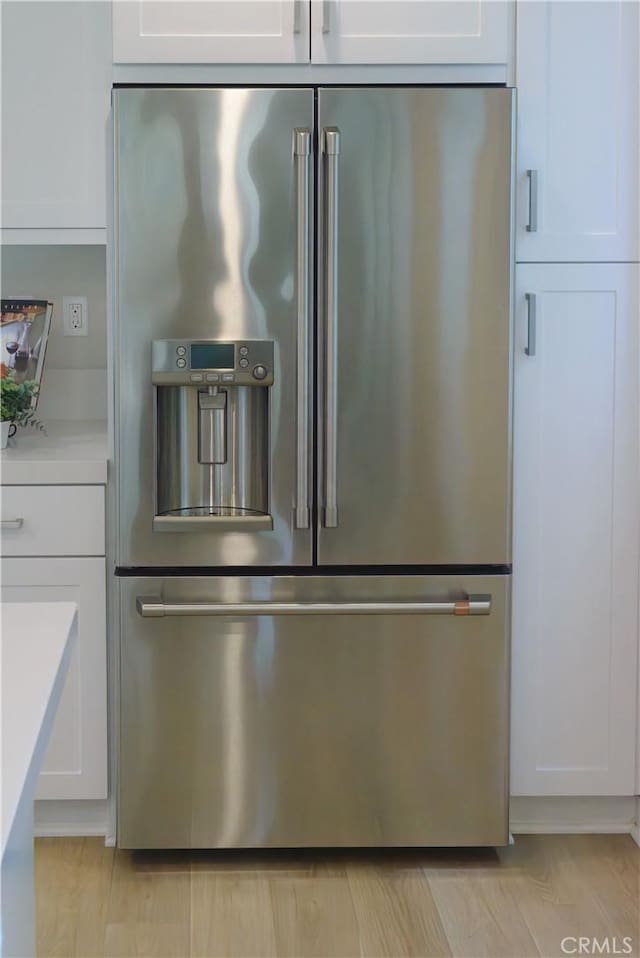21 Welltree Way, Rancho Mission Viejo, CA 92694 - detailed view of stainless steel fridge with ice dispenser, white cabinetry, and light countertops