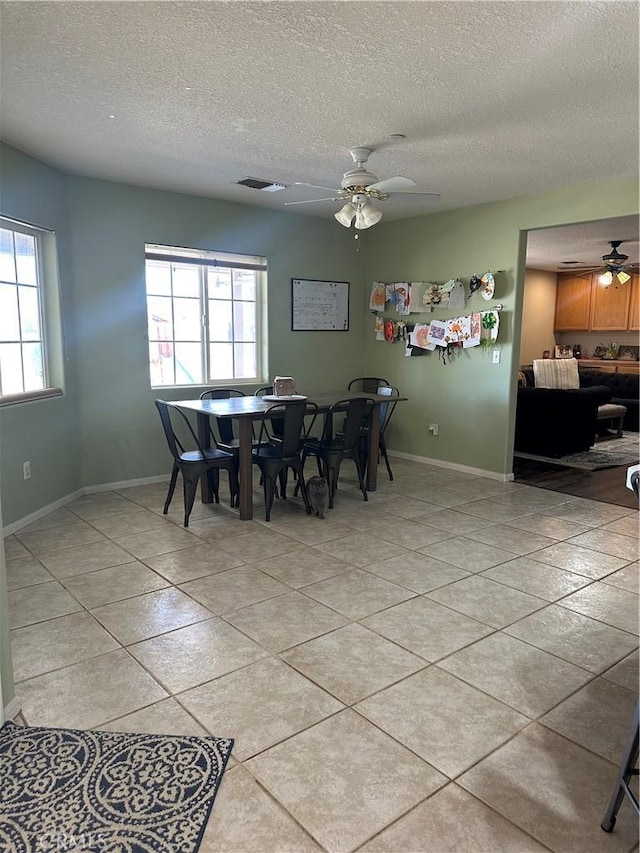 8843 San Diego Dr, Yucca Valley, CA 92284 - dining area with ceiling fan, plenty of natural light, light tile patterned flooring, a textured ceiling, and baseboards