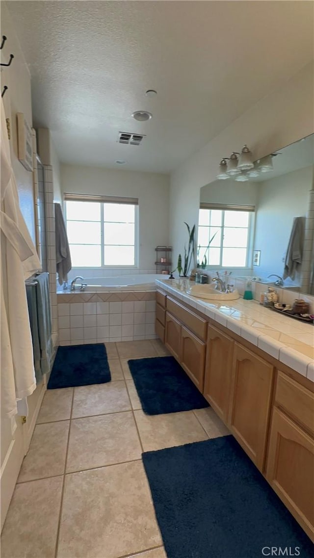 8843 San Diego Dr, Yucca Valley, CA 92284 - full bathroom featuring a bath, healthy amount of natural light, vanity, tile patterned floors, and a textured ceiling