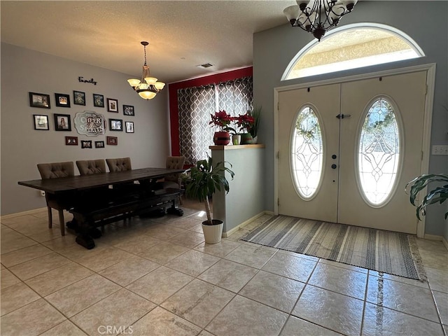 8843 San Diego Dr, Yucca Valley, CA 92284 - entryway featuring a chandelier and light tile patterned floors