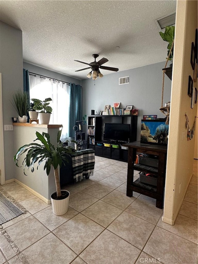 8843 San Diego Dr, Yucca Valley, CA 92284 - living area with a ceiling fan, a textured ceiling, and tile patterned flooring