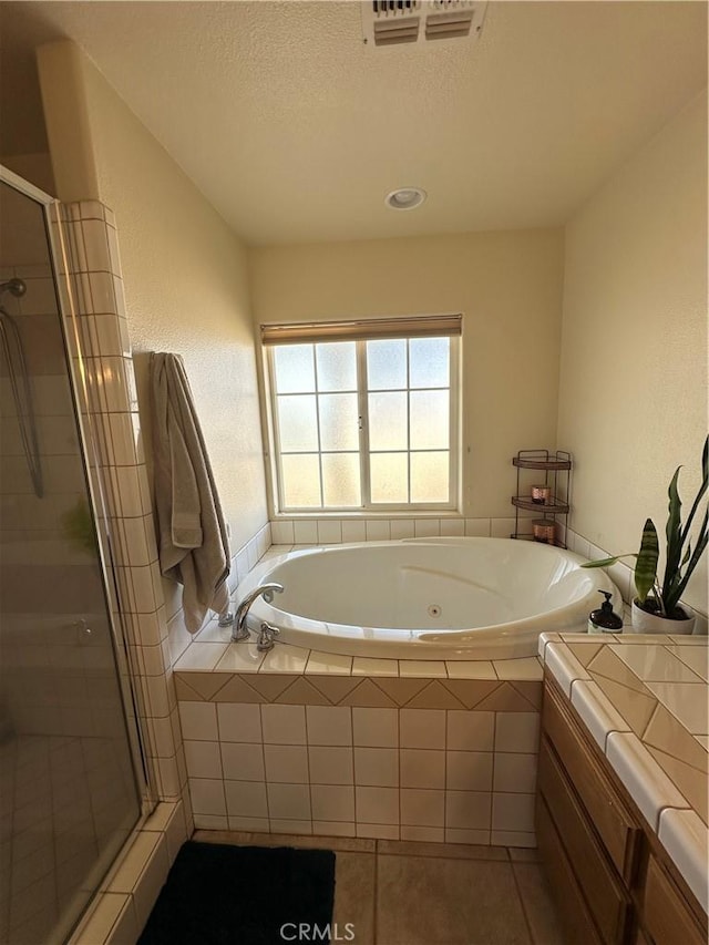 8843 San Diego Dr, Yucca Valley, CA 92284 - full bathroom with a shower stall, a jetted tub, tile patterned flooring, a textured ceiling, and vanity