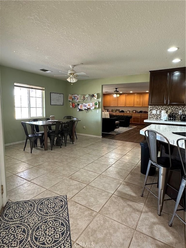 8843 San Diego Dr, Yucca Valley, CA 92284 - dining space with ceiling fan, baseboards, a textured ceiling, and light tile patterned floors