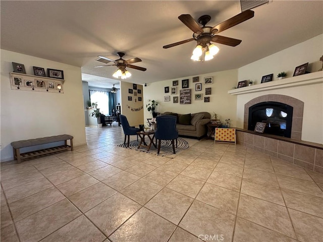 8843 San Diego Dr, Yucca Valley, CA 92284 - living room featuring a ceiling fan, a fireplace, and light tile patterned flooring