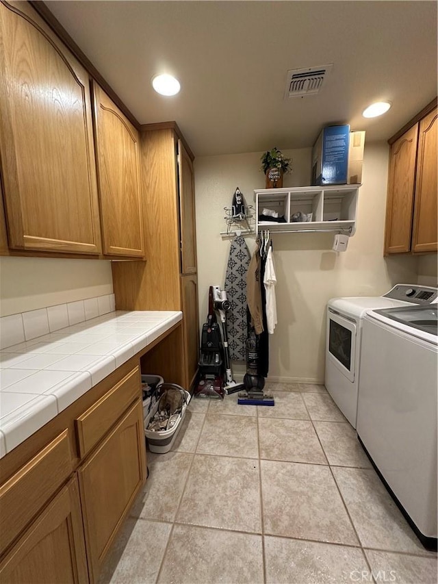 8843 San Diego Dr, Yucca Valley, CA 92284 - washroom featuring cabinet space, separate washer and dryer, light tile patterned floors, and recessed lighting