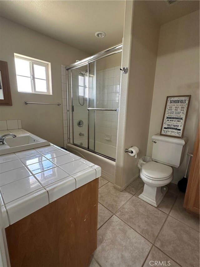 8843 San Diego Dr, Yucca Valley, CA 92284 - full bath with vanity, toilet, tile patterned floors, and enclosed tub / shower combo