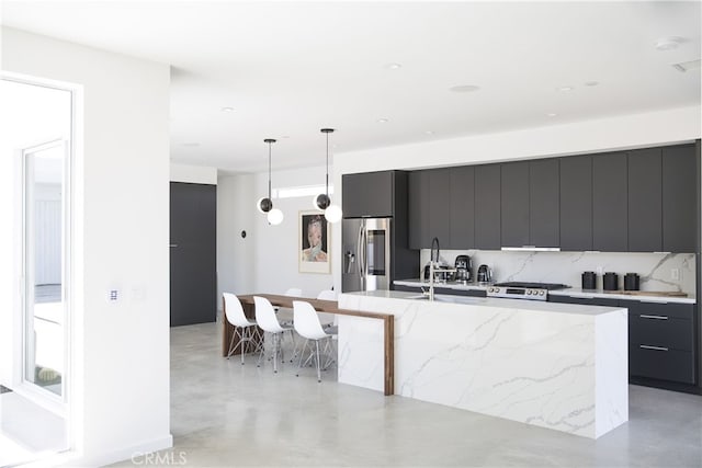 7035 Sunny Vista Rd, Joshua Tree, CA 92252 - kitchen featuring modern cabinets, stainless steel fridge, a large island, and dark cabinetry