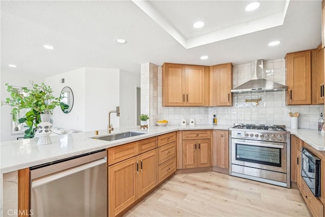 23 Santa Isabel, Rancho Santa Margarita, CA 92688 - kitchen featuring wall chimney range hood, stainless steel appliances, light wood-style flooring, a sink, and backsplash