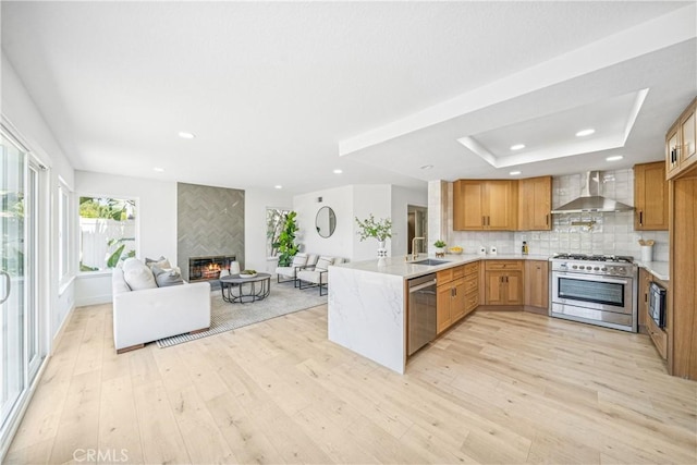 23 Santa Isabel, Rancho Santa Margarita, CA 92688 - kitchen featuring stainless steel appliances, wall chimney exhaust hood, a sink, light wood-type flooring, and recessed lighting