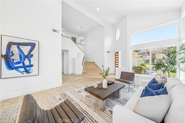 23 Santa Isabel, Rancho Santa Margarita, CA 92688 - living room with a towering ceiling, baseboards, wood finished floors, stairway, and recessed lighting