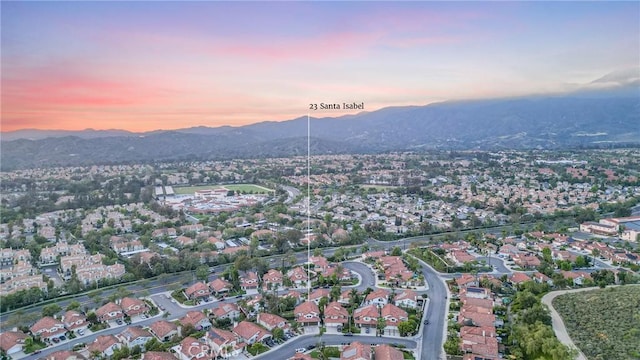 23 Santa Isabel, Rancho Santa Margarita, CA 92688 - aerial overview of property's location featuring a mountainous background and nearby suburban area