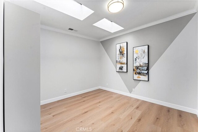 1960 Chariton St, Los Angeles, CA 90034 - spare room featuring a skylight, wood finished floors, crown molding, and baseboards