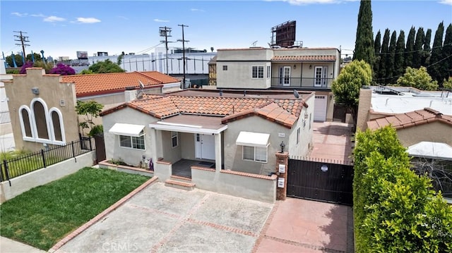 1960 Chariton St, Los Angeles, CA 90034 - mediterranean / spanish home featuring stucco siding, a fenced front yard, a gate, and a tiled roof