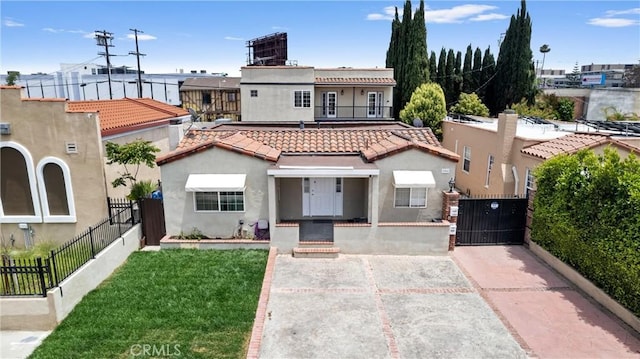 1960 Chariton St, Los Angeles, CA 90034 - mediterranean / spanish-style house with stucco siding, a gate, a tile roof, and a balcony