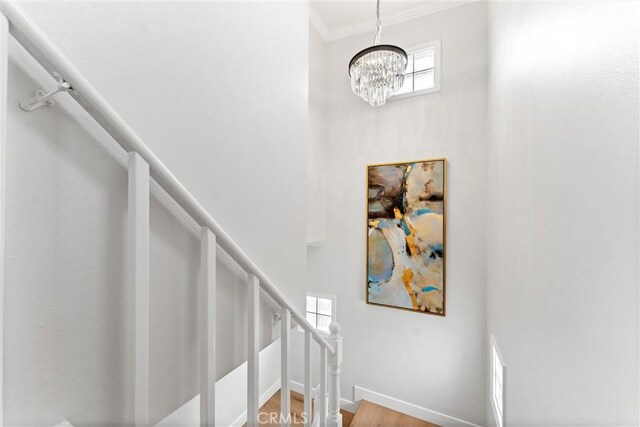 1960 Chariton St, Los Angeles, CA 90034 - staircase featuring a towering ceiling, a chandelier, baseboards, and crown molding