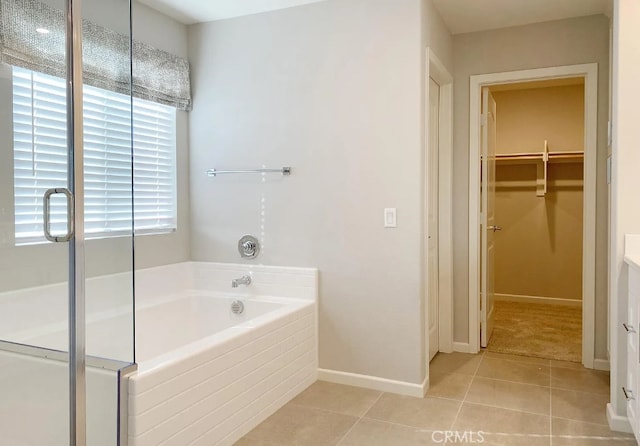 24927 Gulfstream Ln, Moreno Valley, CA 92553 - bathroom featuring a garden tub, tile patterned floors, a spacious closet, baseboards, and vanity