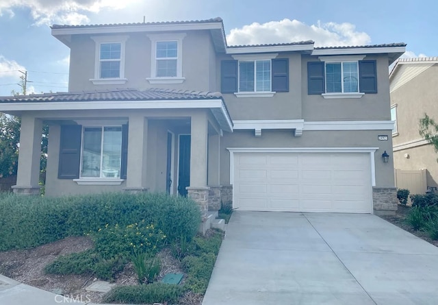24927 Gulfstream Ln, Moreno Valley, CA 92553 - view of front of home with stucco siding, stone siding, and a garage