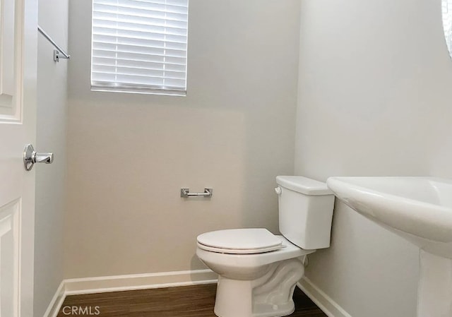 24927 Gulfstream Ln, Moreno Valley, CA 92553 - bathroom with toilet, wood finished floors, and baseboards