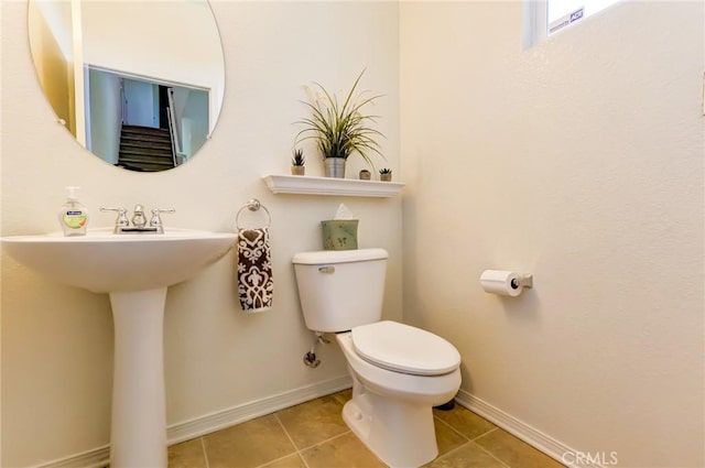 16710 Nicklaus Dr Unit 73, Rancho Cascades, CA 91342 - half bathroom with toilet, tile patterned floors, baseboards, and a sink