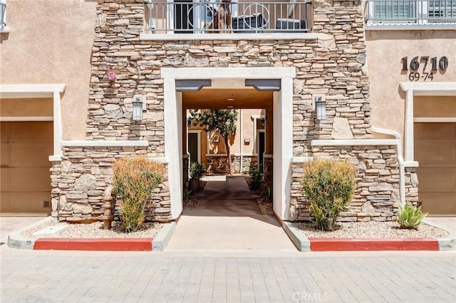16710 Nicklaus Dr Unit 73, Rancho Cascades, CA 91342 - property entrance featuring stone siding, a balcony, and stucco siding