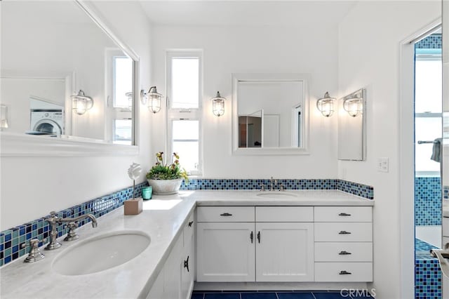 420 34th St, Manhattan Beach, CA 90266 - full bath featuring double vanity, washer / dryer, tasteful backsplash, and tile patterned floors