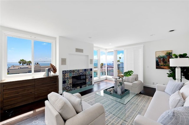 420 34th St, Manhattan Beach, CA 90266 - living room featuring wood finished floors, a tiled fireplace, and recessed lighting
