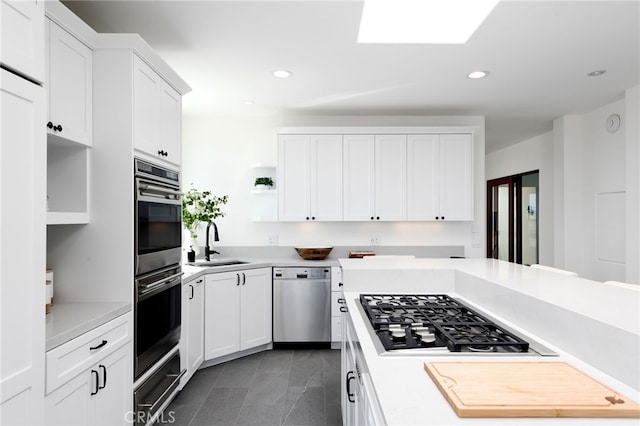 420 34th St, Manhattan Beach, CA 90266 - kitchen with stainless steel appliances, open shelves, light countertops, a warming drawer, and white cabinets