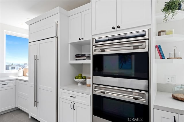 420 34th St, Manhattan Beach, CA 90266 - kitchen featuring stainless steel double oven, open shelves, paneled fridge, and light countertops