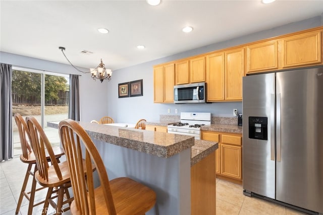 26146 Deer Run St, Menifee, CA 92584 - kitchen featuring appliances with stainless steel finishes, light tile patterned flooring, a kitchen bar, a chandelier, and recessed lighting